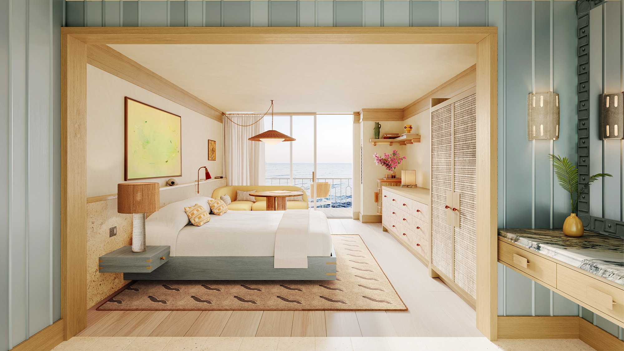 A bright, coastal-style hotel room featuring a king-sized bed, light wood furniture, and a yellow seating area next to a balcony door opening to an ocean view.